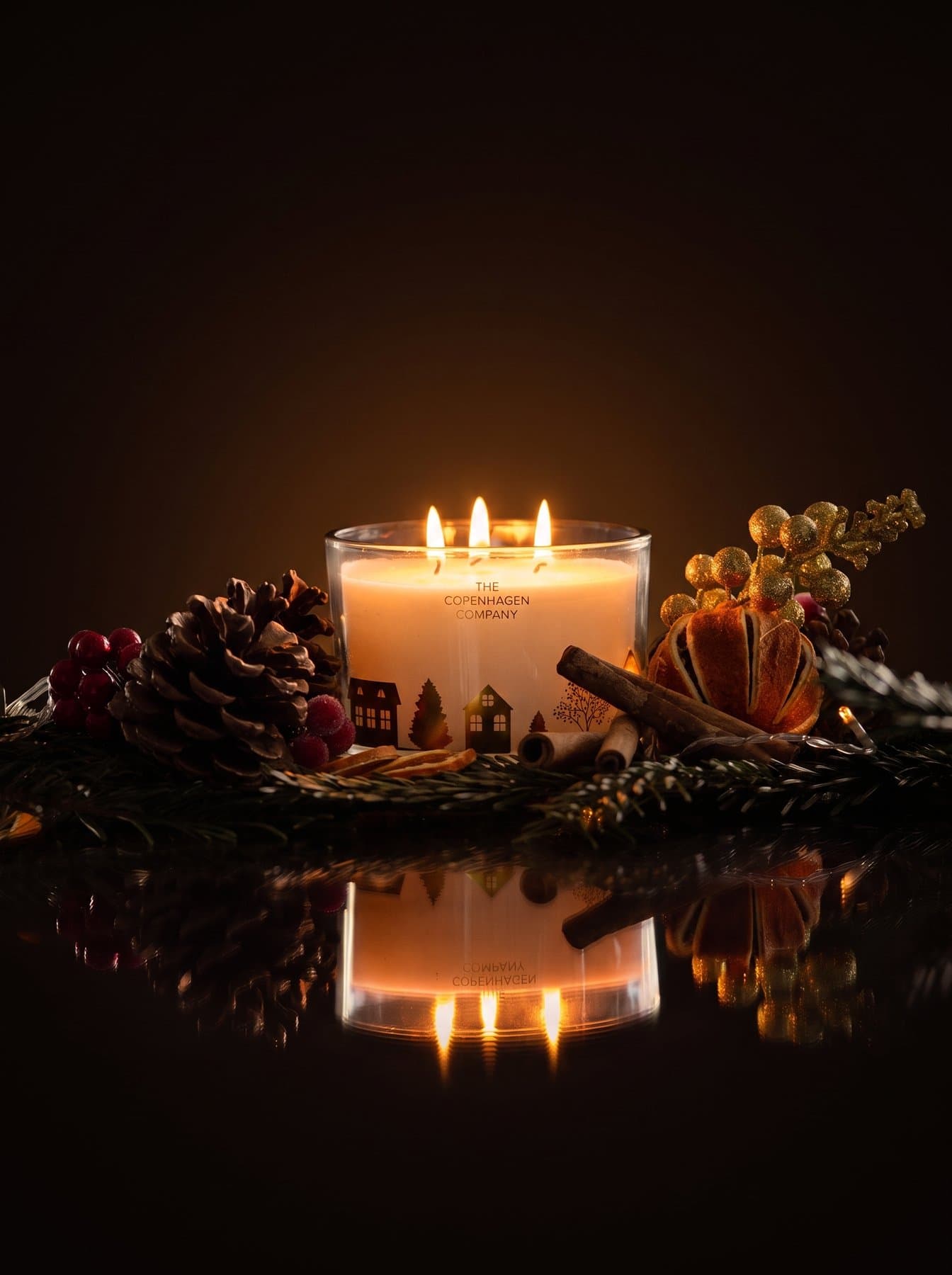 The Christmas candle among pine and dried orange, a second angle