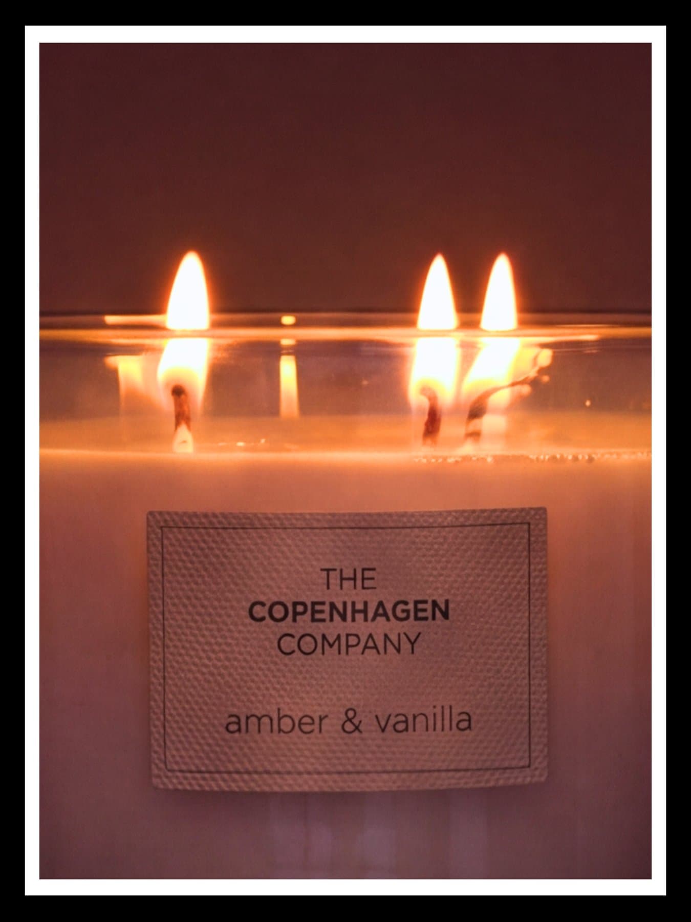 Amber and vanilla, the candle's three flames close