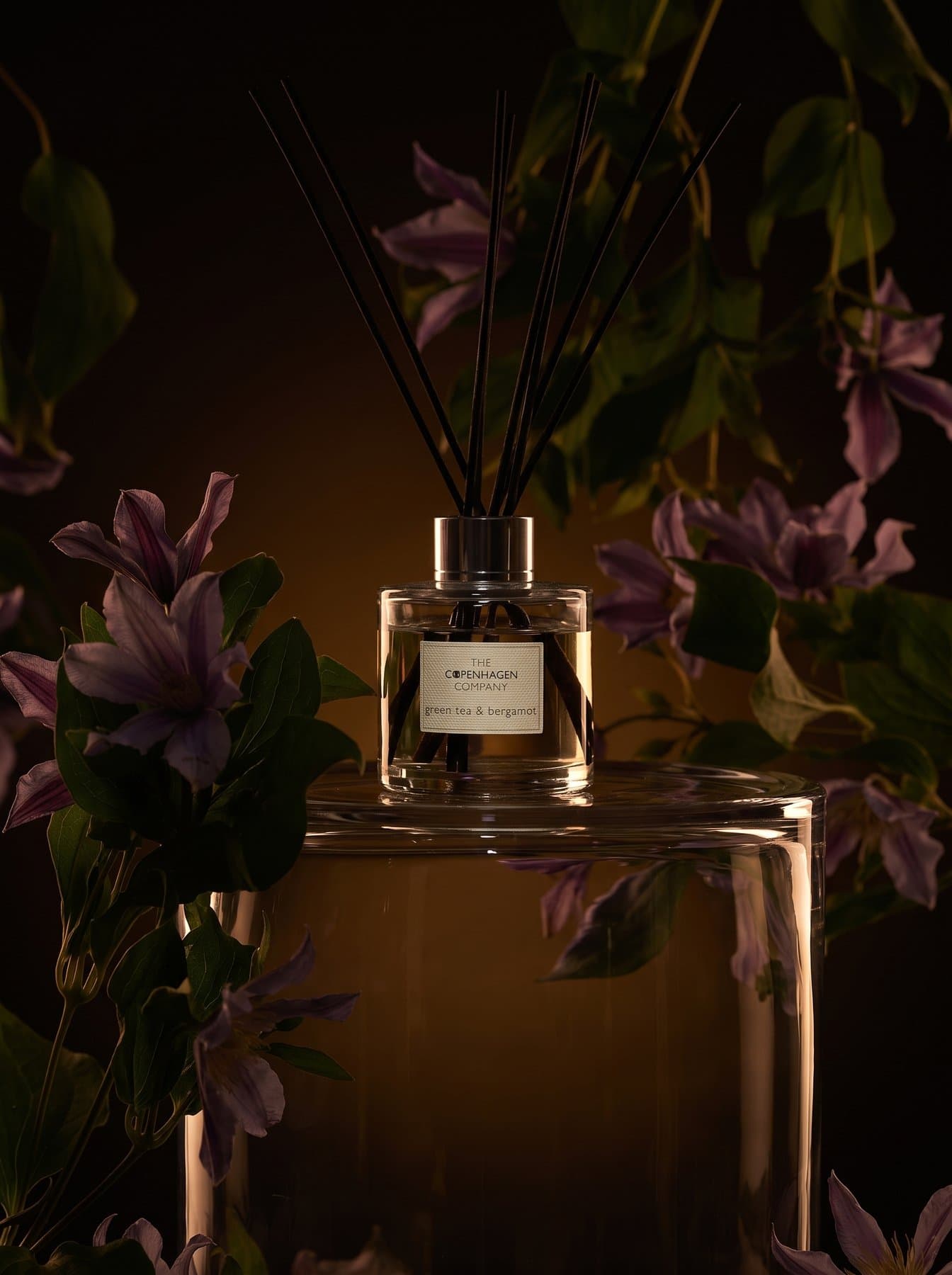 A Signature diffuser among purple lilies, the first angle