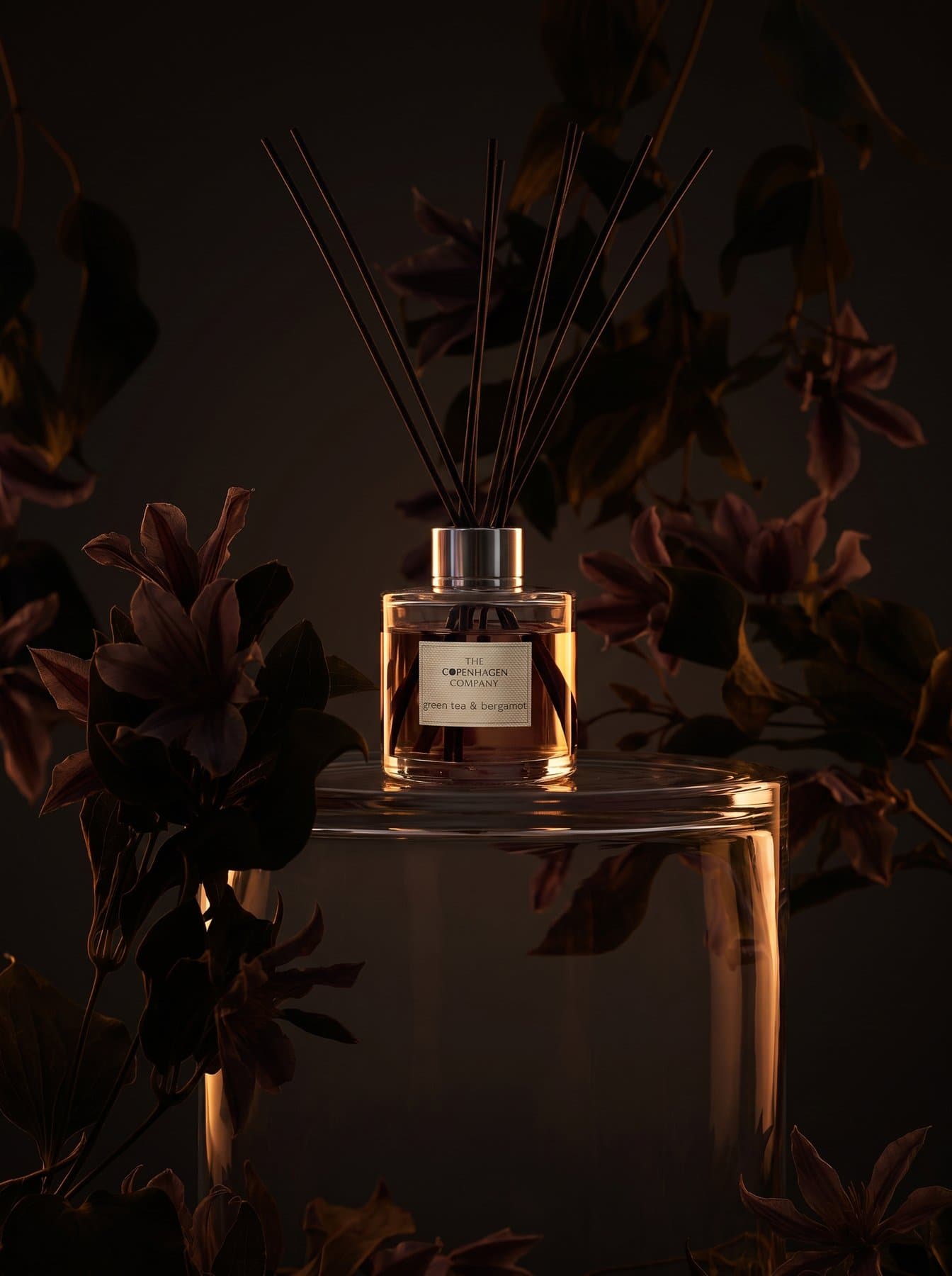 A Signature diffuser among purple lilies