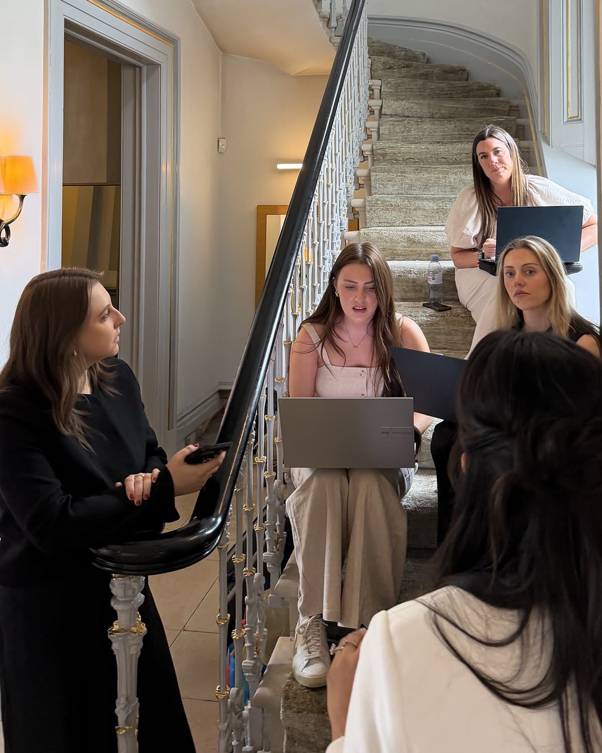 The crew on the stairs with laptops