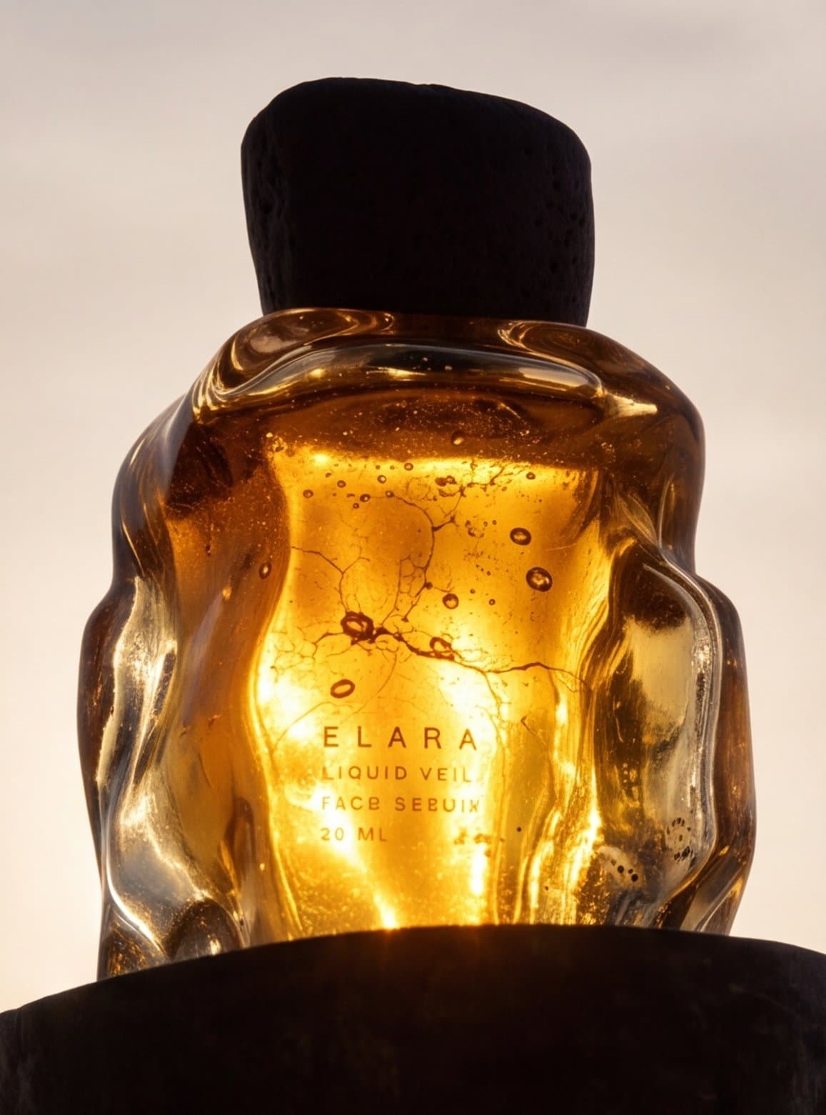 The bottle backlit, the amber lit from within