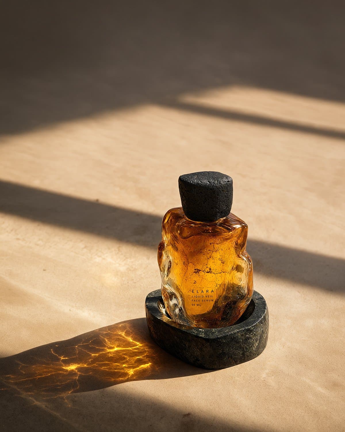 The Liquid Veil bottle on stone in low sun, its shadow thrown gold