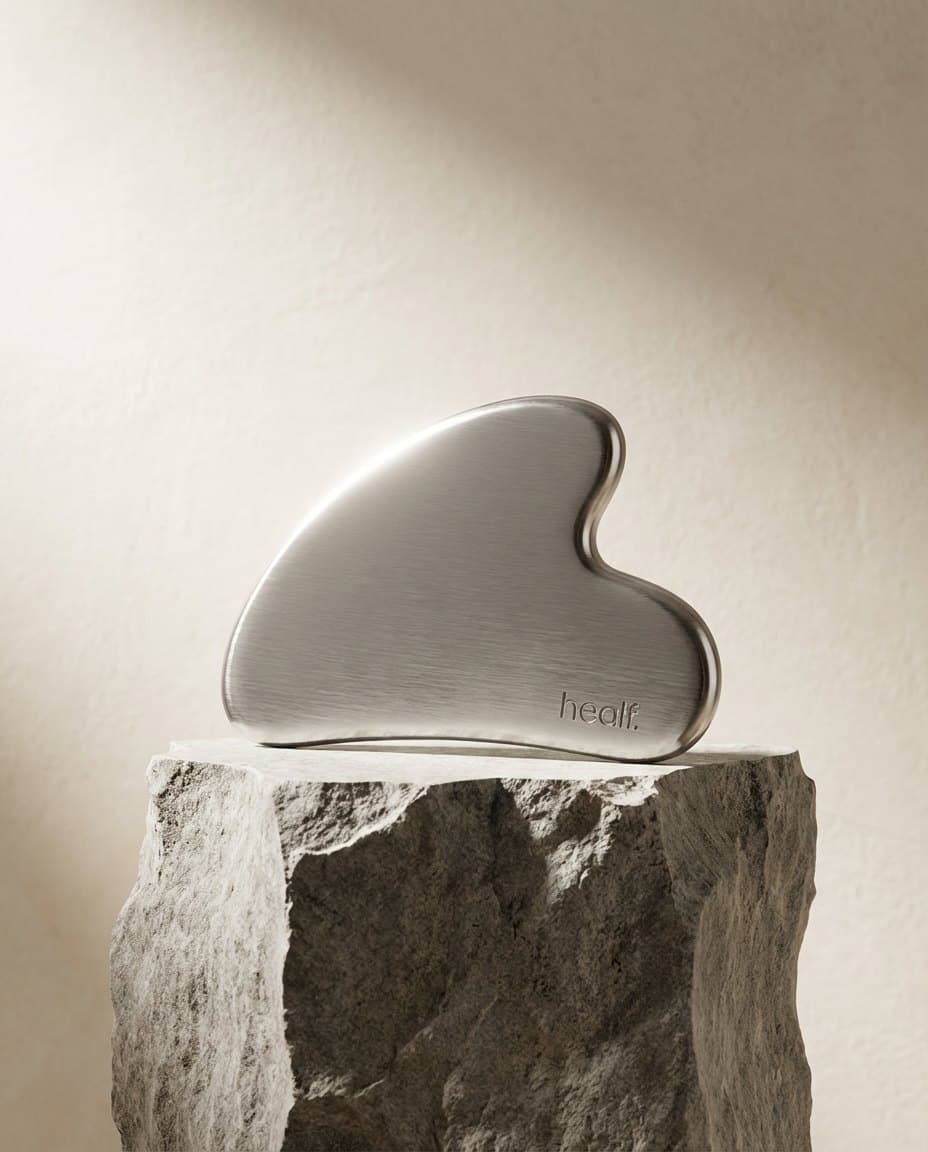 The steel gua sha on a rock