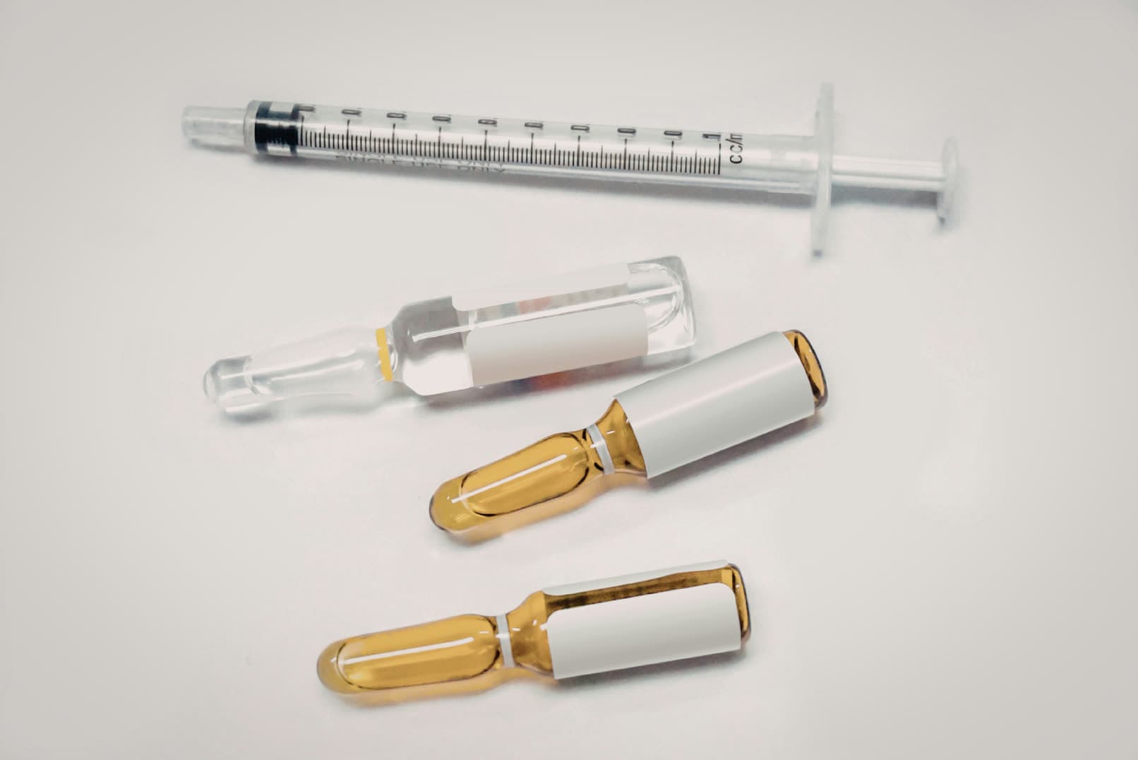 Syringes and ampoules on a white ground