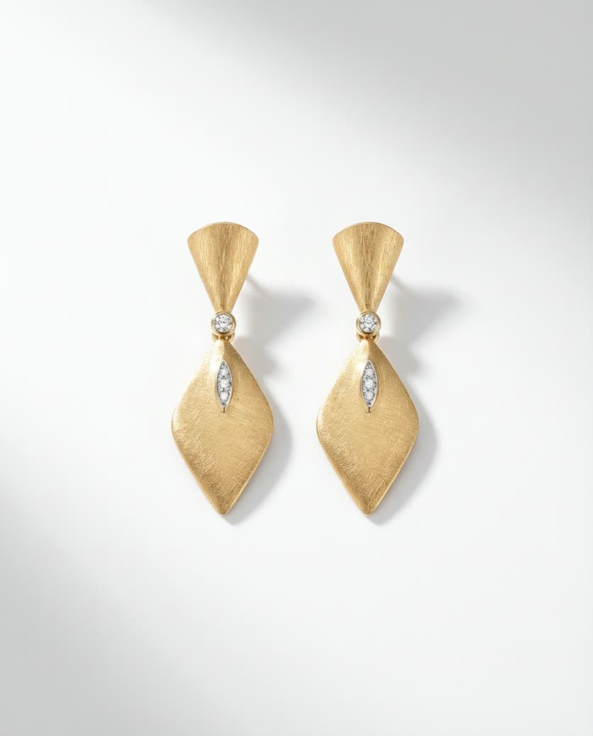 Gold drop earrings on white