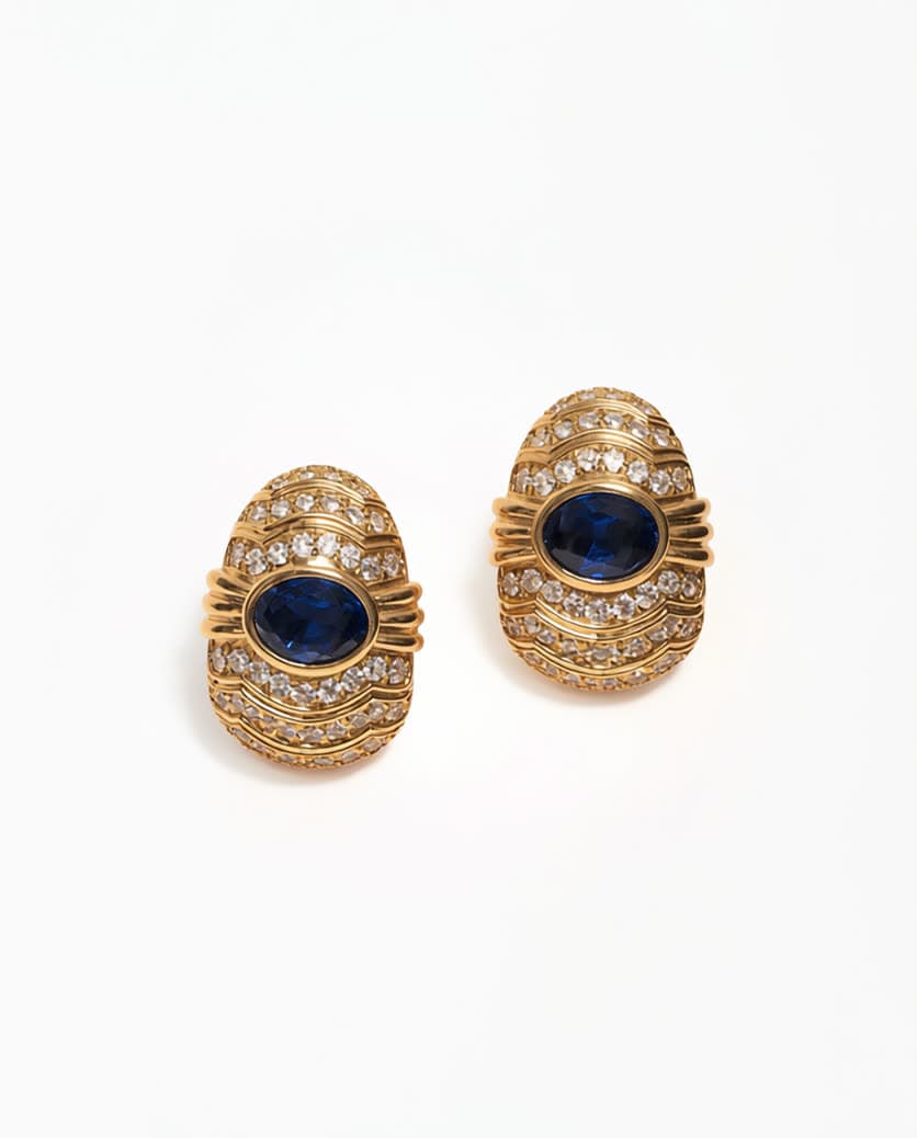 Gold and sapphire earrings on white